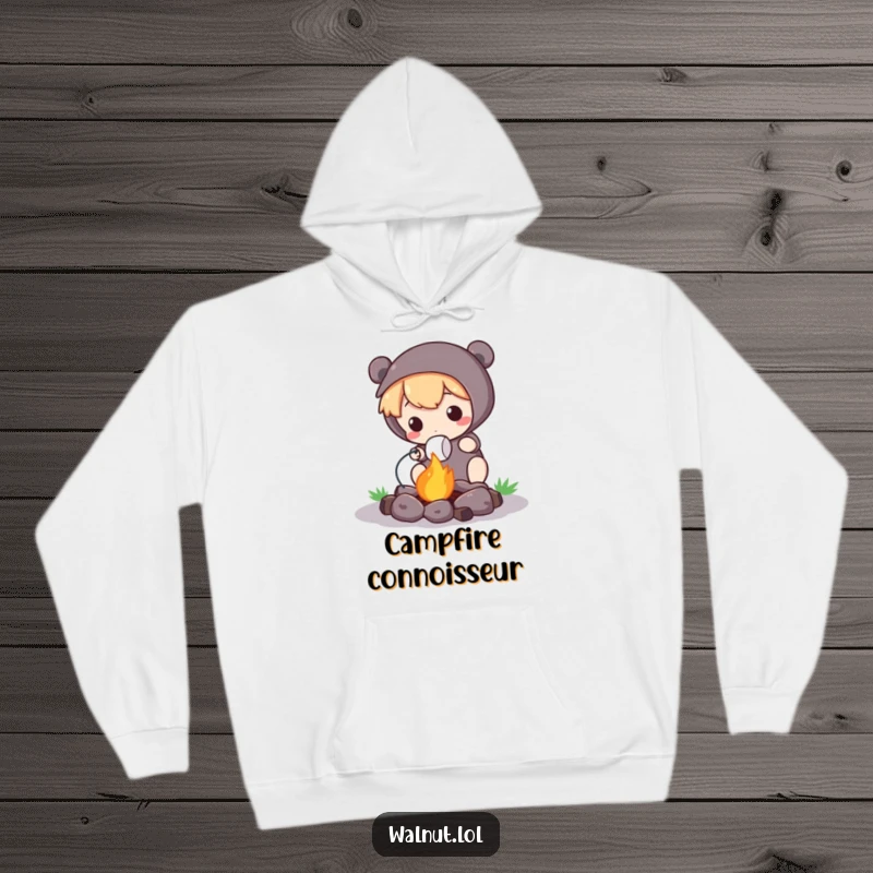 Funny Hoodie depicting a cute character roasting a marshmallow over a tiny campfire, perfect for outdoor warmth and humor.